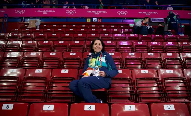 Cristina Romagnoli, a volunteer poses at the venue that hosts the short track speedskating, at the 2026 Winter Olympics, in Milan, Italy, Sunday, Feb. 8, 2026. (AP Photo/Vasilisa Stepanenko
