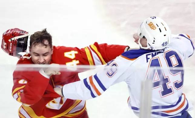 Edmonton Oilers' Ty Emberson, right, fights Calgary Flames' Joel Hanley during the second period of an NHL hockey game in Calgary, Alberta Wednesday, Feb. 4, 2026. (Larry MacDougal/The Canadian Press via AP)