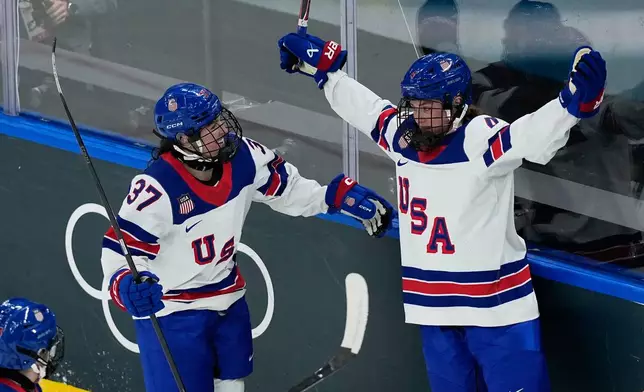 United States' Caroline Harvey, right, celebrates with United States' Abbey Murphy after scoring her sides fifth goal during a preliminary round match of women's ice hockey between the United States and Switzerland at the 2026 Winter Olympics, in Milan, Italy, Monday, Feb. 9, 2026. (AP Photo/Hassan Ammar)