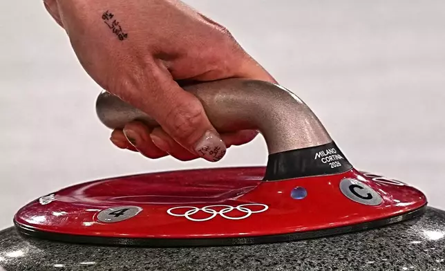 South Korea's Seol Ye-eun in action during the women's curling round robin session against Denmark, at the 2026 Winter Olympics, in Cortina d'Ampezzo, Italy, Saturday, Feb.14, 2026. (AP Photo/Fatima Shbair)
