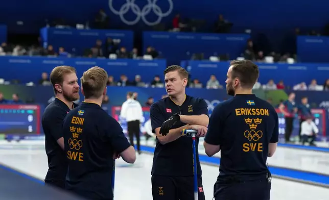 Sweden's Oskar Eriksson, right, Christoffer Sundgren, second right, Rasmus Wranaa, left, and Niklas Edin, second left, in action during the men's curling round robin session against Italy, at the 2026 Winter Olympics, in Cortina d'Ampezzo, Italy, Wednesday, Feb. 11, 2026. (AP Photo/Misper Apawu)
