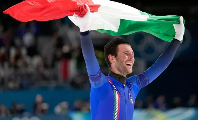 Team Italy's Michele Malfatti celebrates winning the gold medal in the final of the men's team pursuit speedskating race at the 2026 Winter Olympics, in Milan, Italy, Tuesday, Feb. 17, 2026. (AP Photo/Ben Curtis)