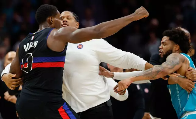 Detroit Pistons center Jalen Duren, left, throws punches with Charlotte Hornets forward Miles Bridges, right, during a fight on the court in the second half of an NBA basketball game in Charlotte, N.C., Monday, Feb. 9, 2026. (AP Photo/Nell Redmond)