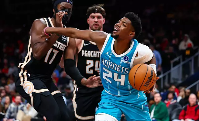 Charlotte Hornets forward Brandon Miller (24) dribbles against Atlanta Hawks forward Onyeka Okongwu (17) during the first half of an NBA basketball game, Saturday, Feb. 7, 2026, in Atlanta. (AP Photo/Colin Hubbard)
