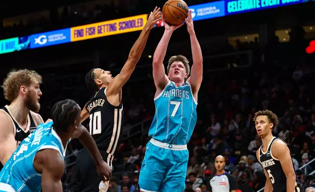 Charlotte Hornets guard Kon Knueppel (7) looks to shoot against Atlanta Hawks forward Zaccharie Risacher (10) during the first half of an NBA basketball game, Saturday, Feb. 7, 2026, in Atlanta. (AP Photo/Colin Hubbard)