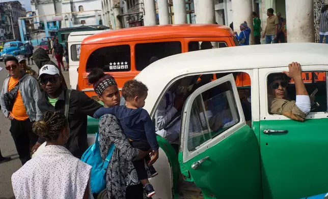 People wait their turns to board shared taxis in Havana, Cuba, Friday, Feb. 6, 2026. (AP Photo/Ramon Espinosa)