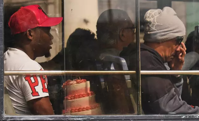 A commuter carries a cake in Havana, Cuba, Friday, Feb. 6, 2026. (AP Photo/Ramon Espinosa)