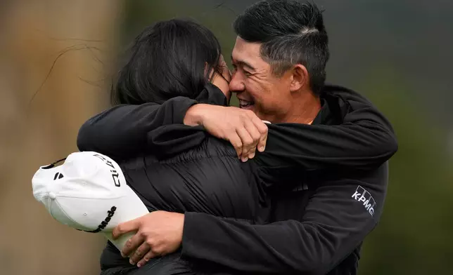 Collin Morikawa, right, celebrates with his wife, Katherine Zhu, after making a birdie putt on the 18th hole at Pebble Beach Golf Links during the final round to win the AT&amp;T Pebble Beach Pro-Am golf tournament in Pebble Beach, Calif., Sunday, Feb. 15, 2026. (AP Photo/Godofredo A. Vásquez)