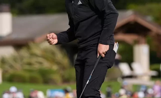 Collin Morikawa celebrates after making a birdie putt on the 18th hole at Pebble Beach Golf Links during the final round to win the AT&amp;T Pebble Beach Pro-Am golf tournament in Pebble Beach, Calif., Sunday, Feb. 15, 2026. (AP Photo/Godofredo A. Vásquez)
