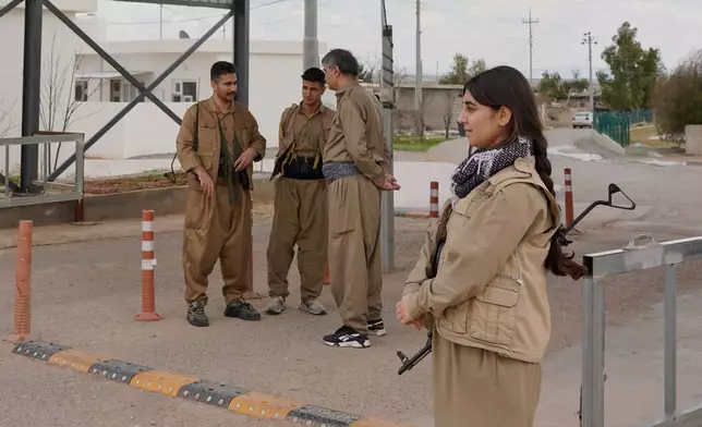 Members of the Democratic Party of Iranian Kurdistan PDKI stand at a checkpoint leading to their base in the Koya district of Irbil, Iraq, Friday, Feb. 27, 2026. (AP Photo/Rashid Yahya)