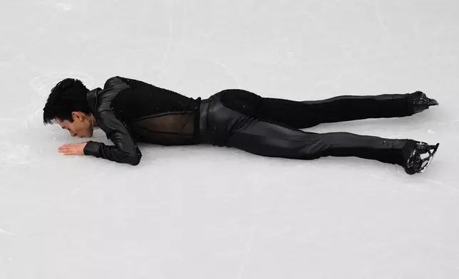 Donovan Carrillo of Mexico kisses the ice after competing during the men's free skate program in figure skating at the 2026 Winter Olympics, in Milan, Italy, Friday, Feb. 13, 2026. (AP Photo/Francisco Seco)