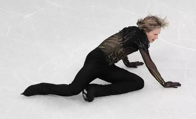 Ilia Malinin of the United States falls during the men's free skate program in figure skating at the 2026 Winter Olympics, in Milan, Italy, Friday, Feb. 13, 2026. (AP Photo/Francisco Seco)