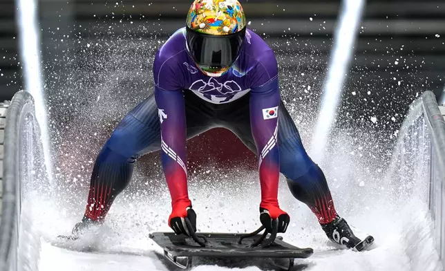South Korea's Jisoo Kim arrives at the finish during a men's skeleton run at the 2026 Winter Olympics, in Cortina d'Ampezzo, Italy, Friday, Feb. 13, 2026. (AP Photo/Aijaz Rahi)