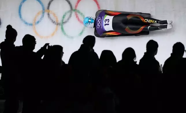 China's Zhao Dan slides down the track during a women's skeleton run at the 2026 Winter Olympics, in Cortina d'Ampezzo, Italy, Friday, Feb. 13, 2026. (AP Photo/Aijaz Rahi)