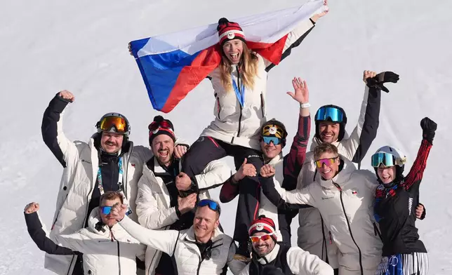 Silver medalist Czechia's Eva Adamczykova celebrates with team members after the women's snowboard cross finals at the 2026 Winter Olympics, in Livigno, Italy, Friday, Feb. 13, 2026. (AP Photo/Lindsey Wasson)
