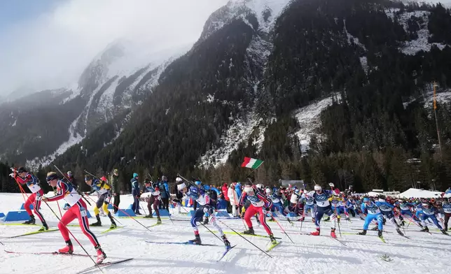 Sturla Holm Laegreid, of Norway, left, and Johan-Olav Botn, of Norway, lead a group during the men's 15-kilometer mass start biathlon race at the 2026 Winter Olympics in Anterselva, Italy, Friday, Feb. 20, 2026. (AP Photo/Andrew Medichini)