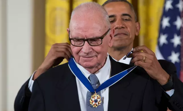 FILE - President Barack Obama, right, presents the Presidential Medal of Freedom to former Rep. Lee Hamilton, D-Ind., during a ceremony in the East Room of the White House, Nov. 24, 2015, in Washington. (AP Photo/Evan Vucci, File)