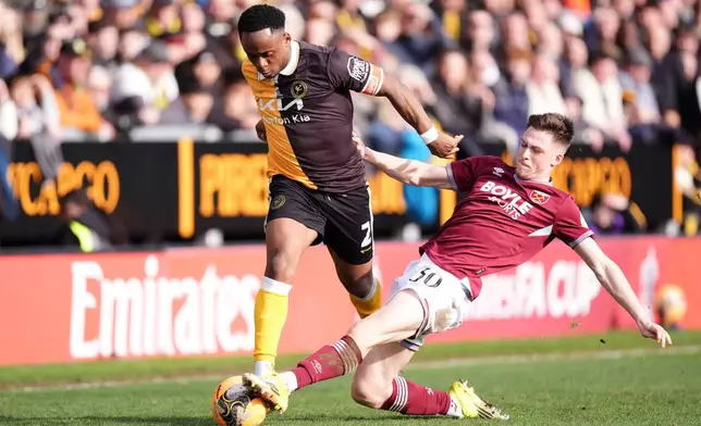 Burton Albion's Udoka Godwin-Malife, left, and West Ham United's Oliver Scarles in action during the English FA Cup fourth round soccer match between Burton Albion and West Ham United in Burton upon Trent, England, Saturday Feb. 14, 2026. (Mike Egerton/PA via AP)