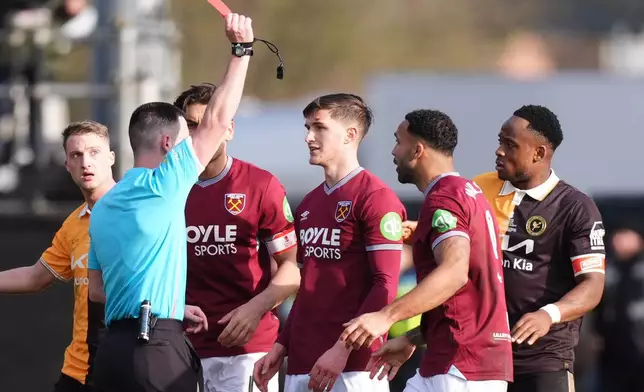 Referee Lewis Smith sends off West Ham United's Freddie Potts, center, during the English FA Cup fourth round soccer match between Burton Albion and West Ham United in Burton upon Trent, England, Saturday Feb. 14, 2026. (Mike Egerton/PA via AP)
