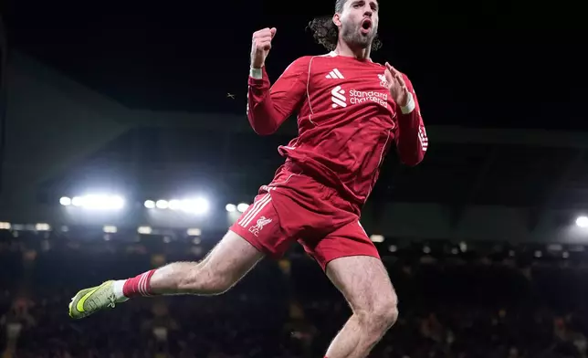 Liverpool's Dominik Szoboszlai jumps up as he celebrates after scoring his sides second goal during the English FA Cup fourth round soccer match between Liverpool and Brighton and Hove Albion in Liverpool, England, Saturday, Feb. 14, 2026. (Peter Byrne/PA via AP)