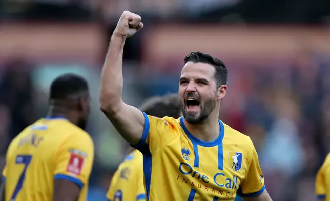 Mansfield Town's Stephen McLaughlin celebrates scoring during the English FA Cup fourth round soccer match between Burnley and Mansfield Town in Burnley, England, Saturday Feb. 14, 2026. (Richard Sellers/PA via AP)