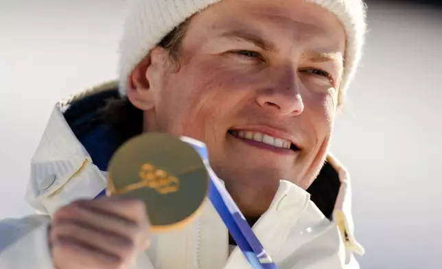 Johannes Hoesflot Klaebo, of Norway, poses after winning the gold medal in the cross country skiing men's 10km interval start free at the 2026 Winter Olympics, in Tesero, Italy, Friday, Feb. 13, 2026. (AP Photo/Evgeniy Maloletka)