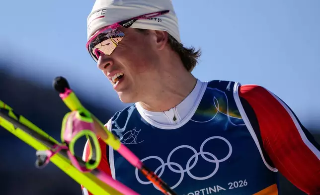 Johannes Hoesflot Klaebo, of Norway, reacts after crossing the finish line in the cross country skiing men's 10km interval start free at the 2026 Winter Olympics, in Tesero, Italy, Friday, Feb. 13, 2026. (AP Photo/Evgeniy Maloletka)
