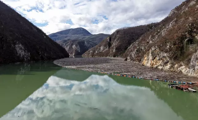 An aerial view shows tons of waste clogging the Drina river in Visegrad, Bosnia, Thursday, Feb. 5, 2026. (AP Photo/Armin Durgut)