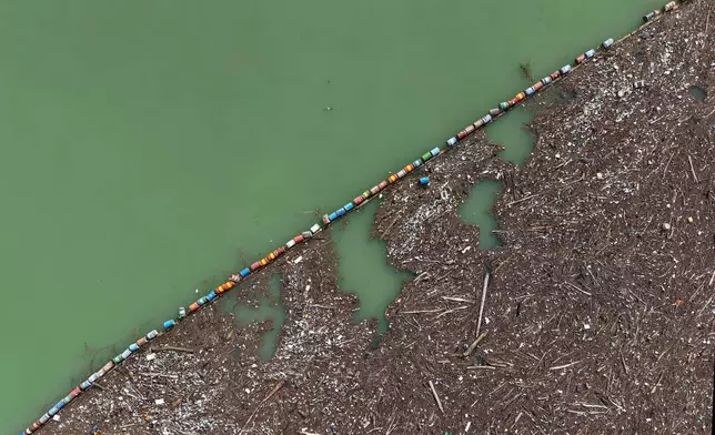 An aerial view shows tons of waste clogging the Drina river in Visegrad, Bosnia, Thursday, Feb. 5, 2026. (AP Photo/Armin Durgut)