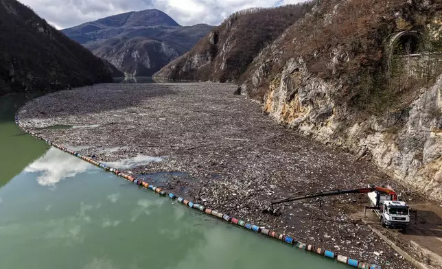 An aerial view shows tons of waste filling the Drina river in Visegrad, Bosnia, Thursday, Feb. 5, 2026. (AP Photo/Armin Durgut)