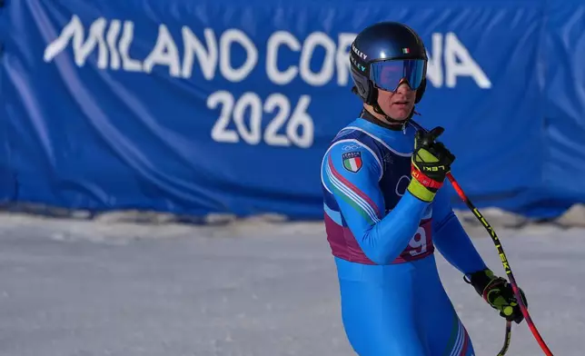 Italy's Giovanni Franzoni celebrates at the finish area of an alpine ski men's downhill portion of a team combined race, at the 2026 Winter Olympics, in Bormio, Italy, Monday, Feb. 9, 2026. (AP Photo/Rebecca Blackwell)