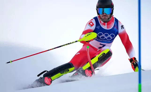 Switzerland's Tanguy Nef speeds down the course of an alpine ski men's slalom portion of a team combined race, at the 2026 Winter Olympics, in Bormio, Italy, Monday, Feb. 9, 2026. (AP Photo/John Locher)