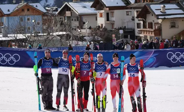Gold medalists Switzerland's Nef Tanguy, right, and teammate Switzerland's Franjo von Allmen, second from right, stand with joint-silver medalists Switzerland's Loic Meillard, third from right, and Switzerland's Marco Odermatt, Austria's Manuel Feller, second from left, and Austria's Vincent Kriechmayr, at the finish area of an alpine ski men's slalom portion of a team combined race, at the 2026 Winter Olympics, in Bormio, Italy, Monday, Feb. 9, 2026. (AP Photo/Rebecca Blackwell)