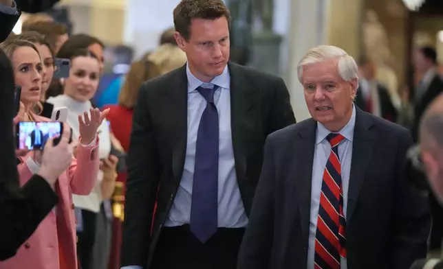 Paramount Skydance chairman and CEO David Ellison arrives with Sen. Lindsey Graham, R-S.C., before President Donald Trump delivers the State of the Union address to a joint session of Congress in the House chamber at the U.S. Capitol in Washington, Tuesday, Feb. 24, 2026. (AP Photo/Mark Schiefelbein)
