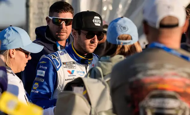 Chase Elliott signs autographs during practice at the NASCAR Daytona 500 auto races at Daytona International Speedway, Friday, Feb. 13, 2026, in Daytona Beach, Fla. (AP Photo/Mike Stewart)