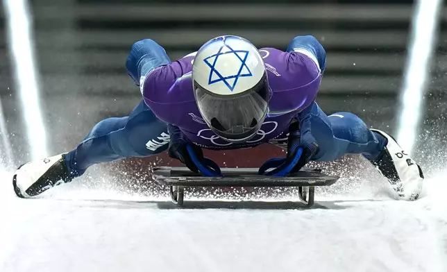 Israel's Jared Firestone arrives at the finish during a men's skeleton training session at the 2026 Winter Olympics, in Cortina d'Ampezzo, Italy, Monday, Feb. 9, 2026. (AP Photo/Aijaz Rahi)