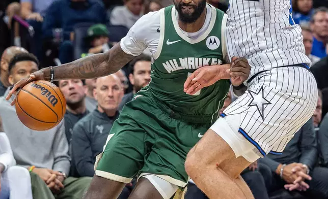 Milwaukee Bucks forward Bobby Portis, left, dribbles on Orlando Magic forward Franz Wagner during the first half of an NBA basketball game, Wednesday, Feb. 11, 2026, in Orlando, Fla. (AP Photo/Willie J. Allen Jr.)