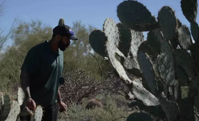 Law enforcement agents check vegetation areas around Nancy Guthrie’s home in Tucson, Ariz., Wednesday, Feb. 11, 2026. (AP Photo/Ty ONeil)