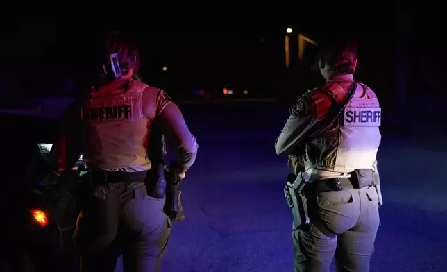 Sheriff's officials block the entrance to a road where a home was being searched in Rio Rico, Arizona, on Tuesday, Feb. 10, 2026, in connection to the investigation of Nancy Guthrie's disappearance. (AP Photo/Ty ONeil)