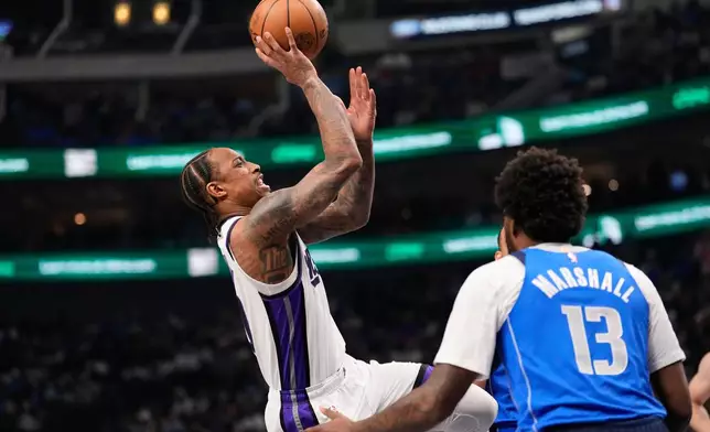 Sacramento Kings guard DeMar DeRozan (10) shoots as Dallas Mavericks' Naji Marshall (13) defends in the first half of an NBA basketball game in Dallas, Thursday, Feb. 26, 2026. (AP Photo/Tony Gutierrez)