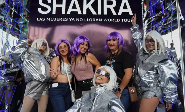 Fans of Colombian pop star Shakira pose for a photo before her concert at the National Stadium in San Salvador, El Salvador, Thursday, Feb. 12, 2026. (AP Photo/Salvador Melendez)