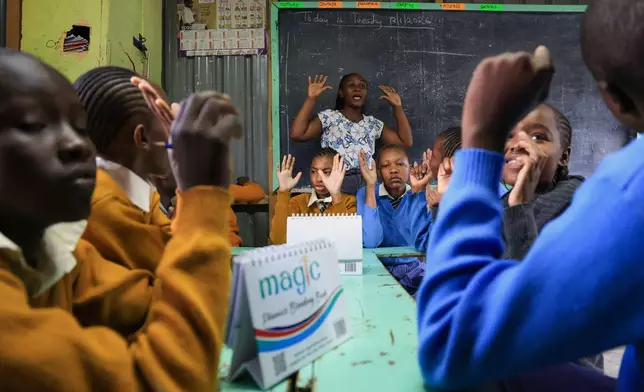 Dorothy Kioko, a teacher, leads a Grade 7 English lesson at Rare Gem Talent School in Kitengela, Kajiado County, Kenya, Tuesday, Jan. 13, 2026. (AP Photo/Andrew Kasuku)