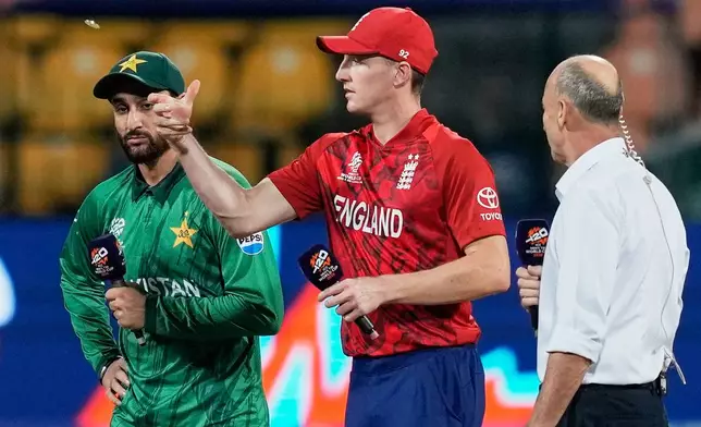 England's captain Harry Brook, centre, tosses the coin as Pakistan's captain Salman Ali Agha looks on before the start of the T20 World Cup cricket match between England and Pakistan in Pallekele, Sri Lanka, Tuesday, Feb. 24, 2026. (AP Photo/Eranga Jayawardena)