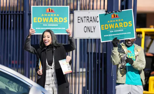 Texas Congressional Candidate Amanda Edwards waves at a voter at a polling location at Acres Homes MultiService Center on Election Day, in Houston, Saturday, Jan. 31, 2026. (AP Photo/ Karen Warren)