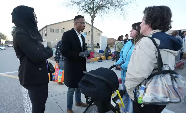 Texas Congressional Candidate Christian Menefee talks with voters as he visited a polling location at Wheeler Avenue Baptist Church on Election Day, in Houston, Saturday, Jan. 31, 2026. (AP Photo/Karen Warren)