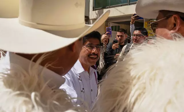 Mexico's Supreme Court President Hugo Aguilar, center, greets Indigenous authorities upon his arrival for a special session in Tenejapa, Chiapas State, Mexico, Thursday, Feb. 26, 2026. (AP Photo/Isabel Mateos)