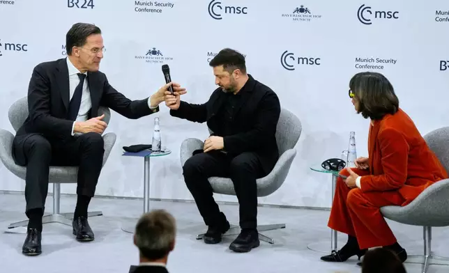 Journalist Christiane Amanpour, right, chairs a panel with Ukraine's President Volodymyr Zelenskyy, center, and NATO Secretary General Mark Rutte at the Munich Security Conference in Munich, Germany, Saturday, Feb. 14, 2026. (AP Photo/Michael Probst)