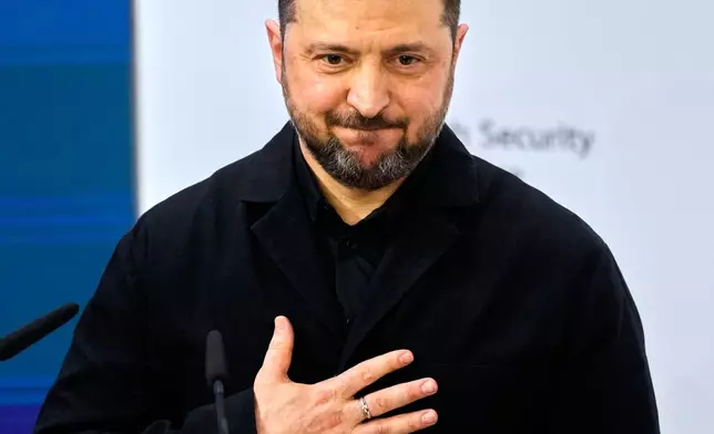 Ukraine's President Volodymyr Zelenskyy aknowledges the audience after delivering an address during a session at the Munich Security Conference in Munich, Germany, Saturday, Feb. 14, 2026. (AP Photo/Michael Probst)