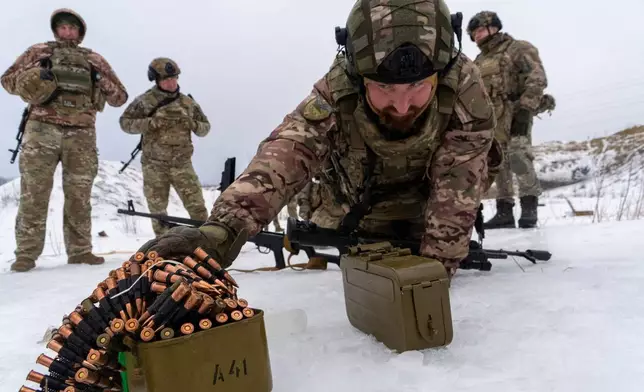 Ukrainian servicemen of special police unit take part in training at the training field in Kharkiv region, Ukraine, Friday, Feb. 13, 2026. (AP Photo/Andrii Marienko)