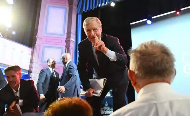 Tom Steyer, right, and Matt Mahan talk to attendees after the California gubernatorial candidate debate Tuesday, Feb. 3, 2026, in San Francisco. (AP Photo/Laure Andrillon)